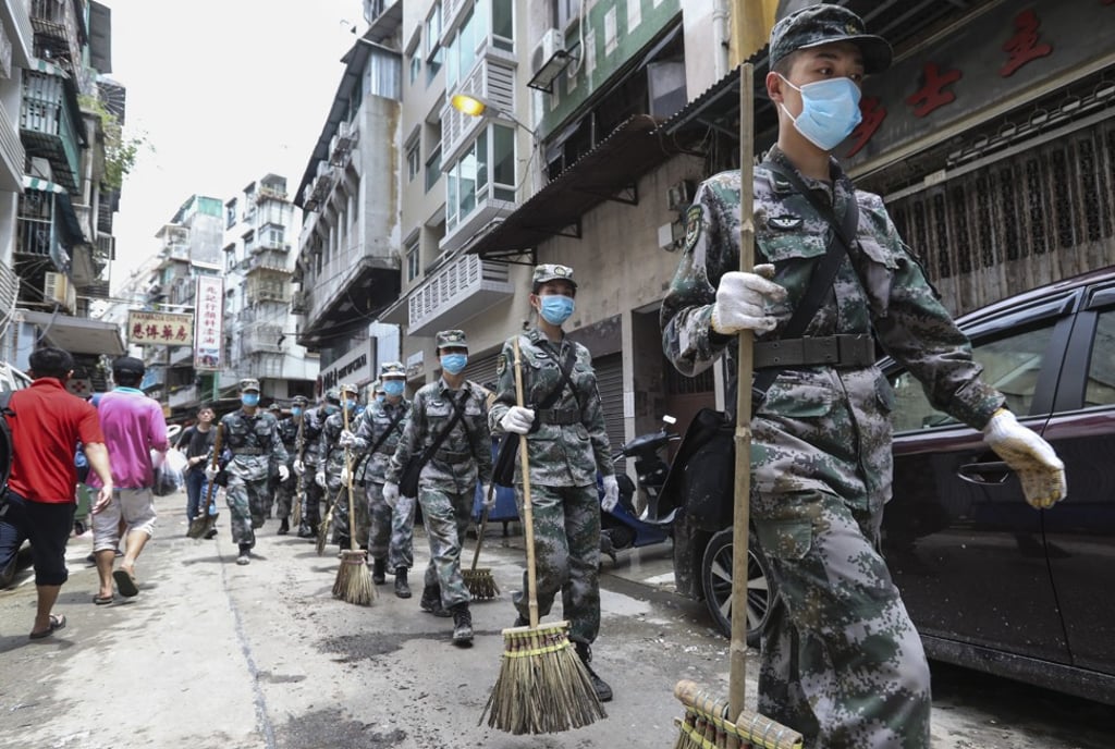 People’s Liberation Army troops help with relief efforts on the streets of Macau in the aftermath of Typhoon Hato in August 2017. Photo: Edward Wong