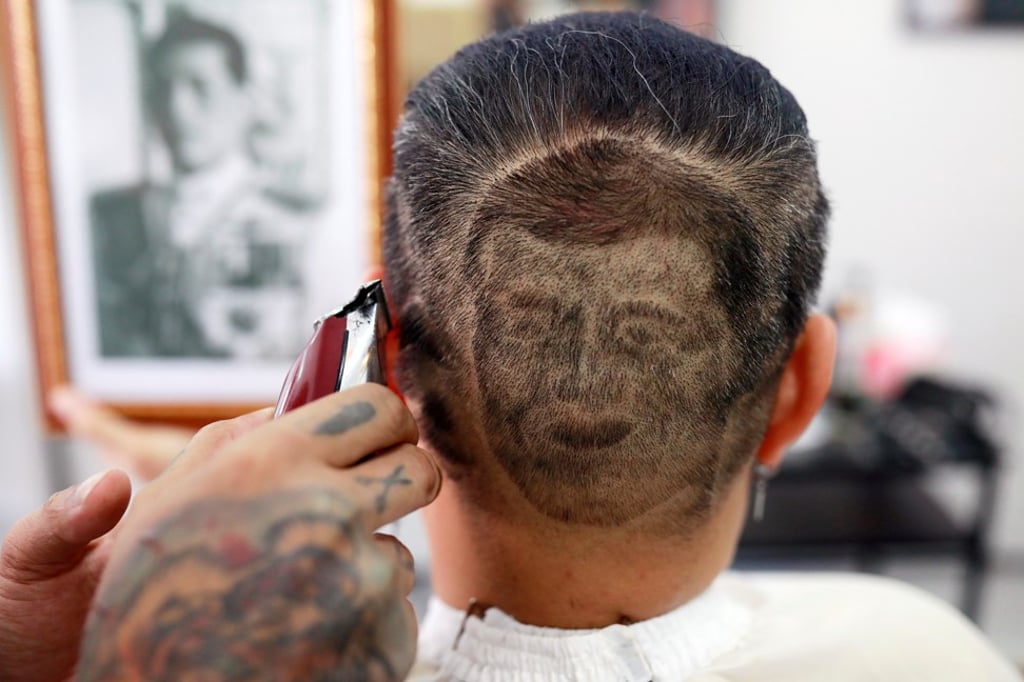 Mitree Chitinunda gets a haircut in the shape of the Thai king’s face. Photo: Reuters