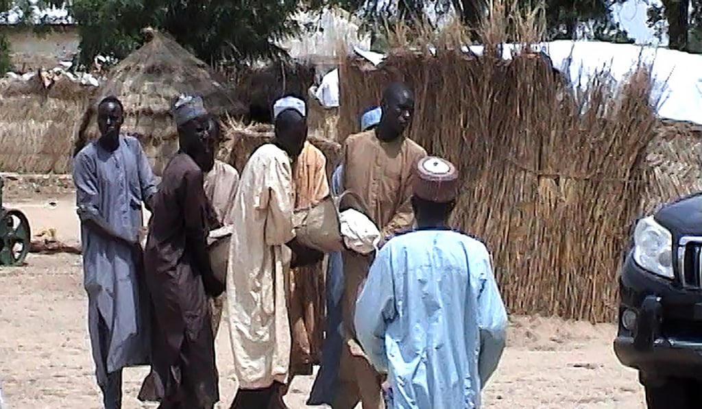 Men carry a victim to a funeral. Photo: AFP