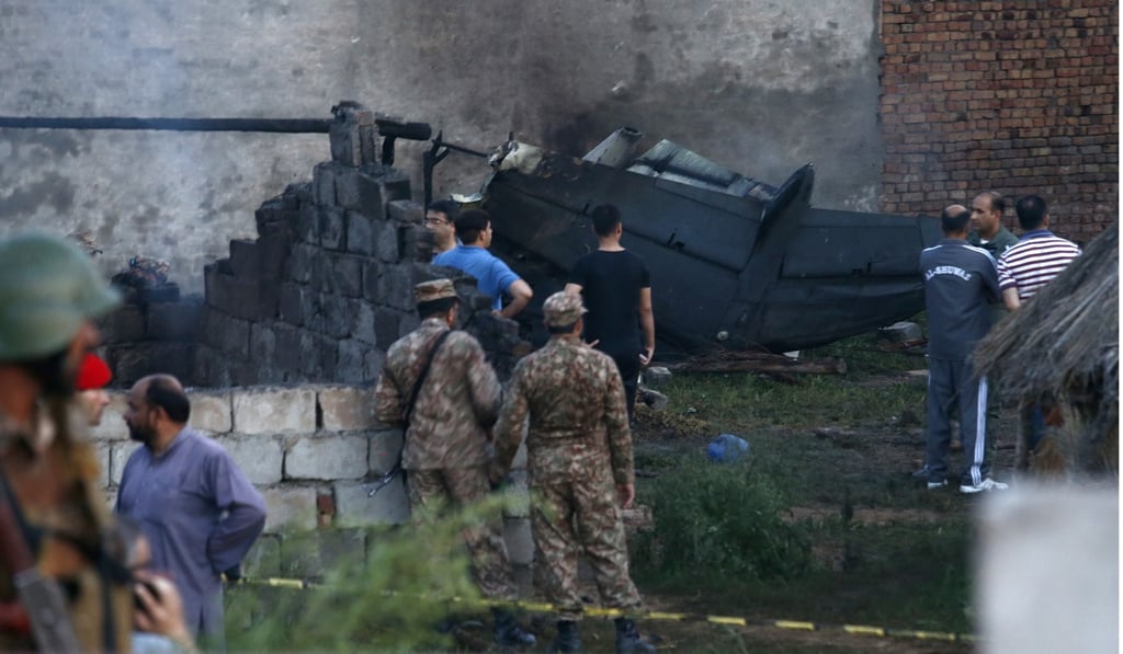 Army officials examine the site of a plane crash in Rawalpindi. Photo: AP