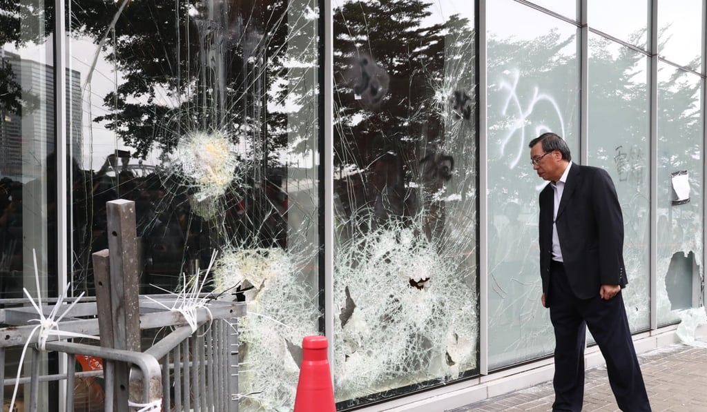 Hong Kong Legislative Council President Andrew Leung inspects the damage to the legislature following the wrecking spree by hard core protesters on July 1. Photo: Nora Tam