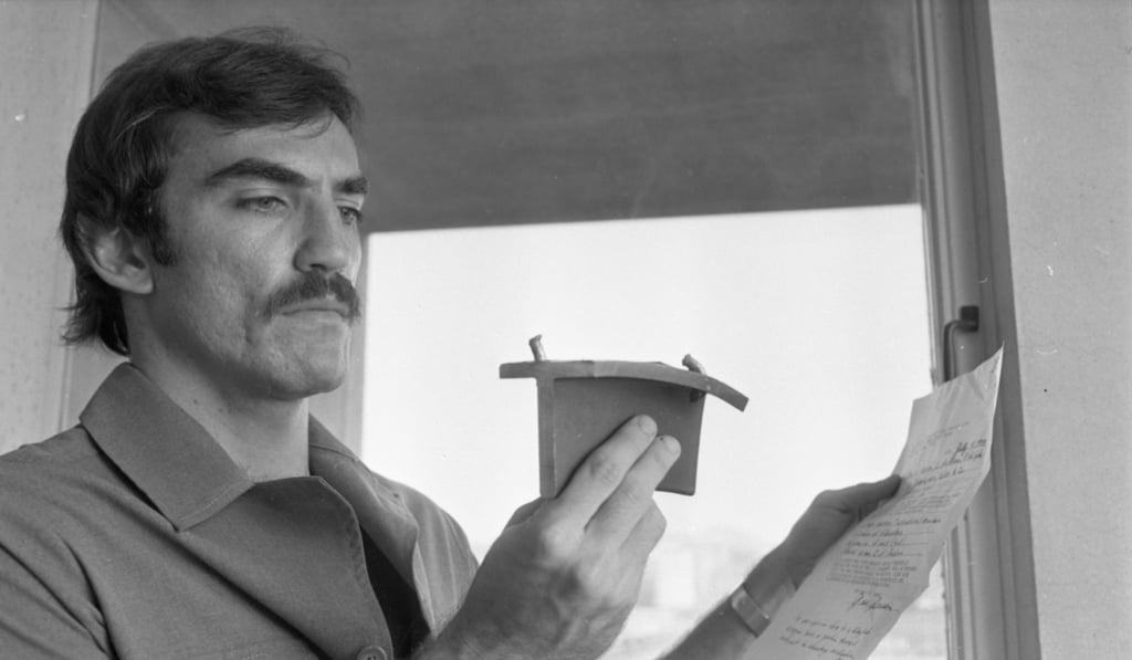 A certificate held by magazine distributor Christopher Watson confirms the material in his right hand is a chunk of Skylab. Photo: SCMP