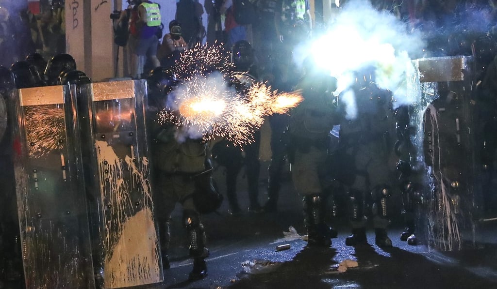 Police officers fire tear gas at protesters in Sai Ying Pun. Photo: Sam Tsang Police officers fire tear gas at protesters in Sai Ying Pun. Photo: Sam Tsang