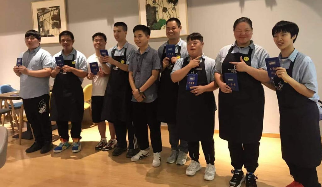 Staff at the Dream Workshop cafe in Shanghai celebrate their first salaries. Photo: Handout