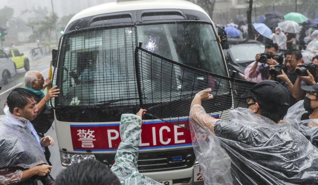 Protesters vandalise a police van outside Eastern Court in Sai Wan Ho as 44 people become the first wave of arrested to face riot charges. Photo: Sam Tsang