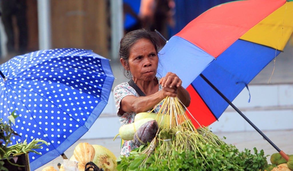 An East Timorese vendor on a sidewalk in Dili. Photo: EPA