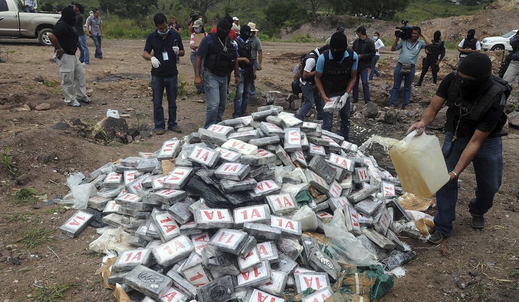 Masked police prepare to destroy seized cocaine on the outskirts of Tegucigalpa, Honduras in 2012. File photo: AP