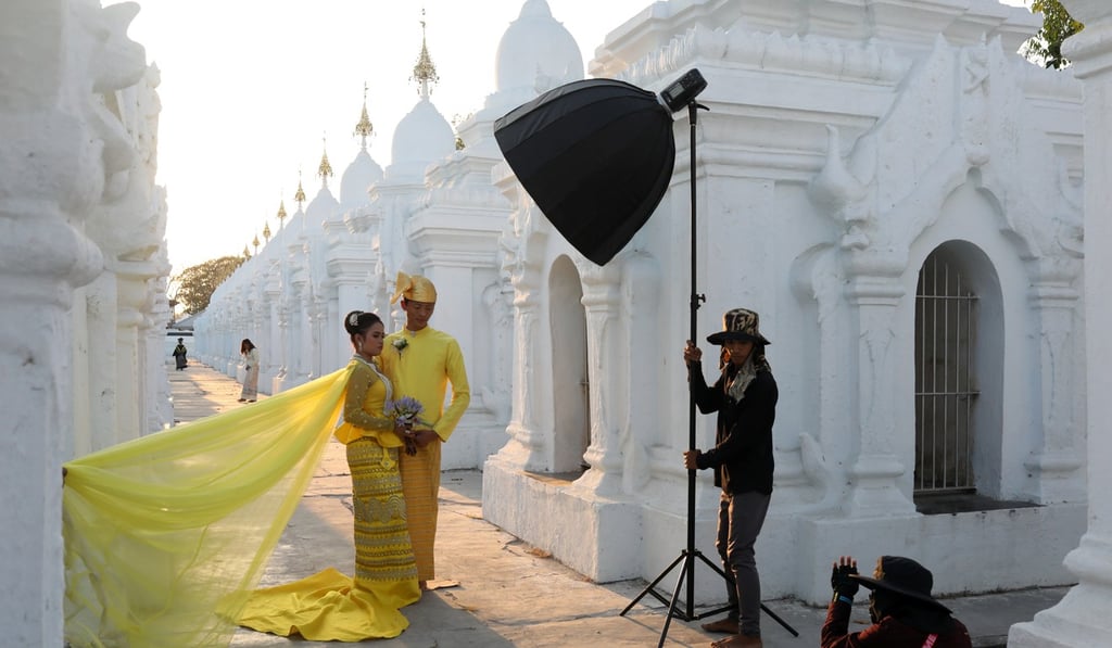 A couple poses for a wedding photo shoot at Kuthodaw Pagoda in Mandalay. Photo: Reuters A couple poses for a wedding photo shoot at Kuthodaw Pagoda in Mandalay. Photo: Reuters