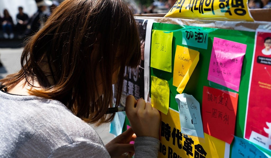 A Lennon Wall at the New York event, echoing those that have appeared all over Hong Kong. Photo: Joy Chang A Lennon Wall at the New York event, echoing those that have appeared all over Hong Kong. Photo: Joy Chang