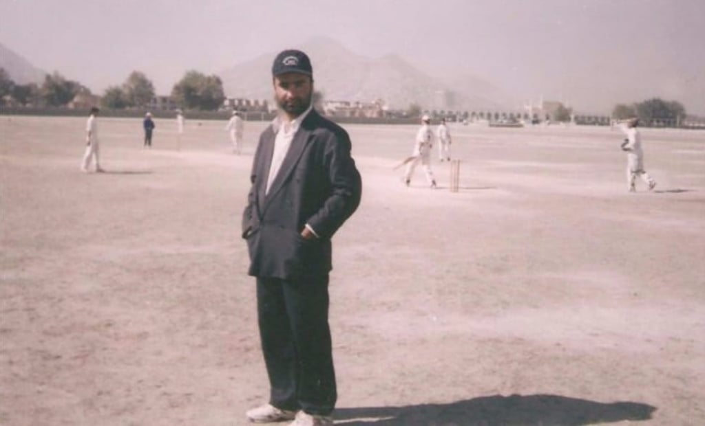 Coach Taj Malik Alam with Afghan cricketers in 2003 at a muddy cricket ground in Kabul Photo: Facebook