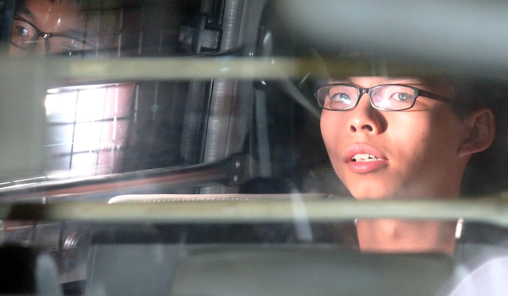 Joshua Wong leaves the High Court in a prison van in 2017 to begin a jail term for storming the Central Government Offices in 2014, an act which triggered the 79-day Occupy Central protest sit-in, also called the “umbrella movement”. Photo: K.Y. Cheng