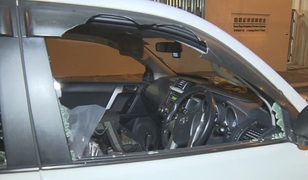 Protesters hammered the van’s windows with blunt objects and tried to open the door of the vehicle. Some protesters also tried to jam traffic cones under the van. Photo: SCMP Pictures