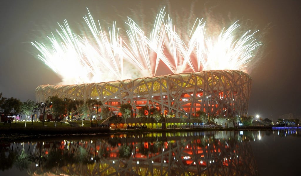 Fireworks explode next to the National Stadium, also known as the