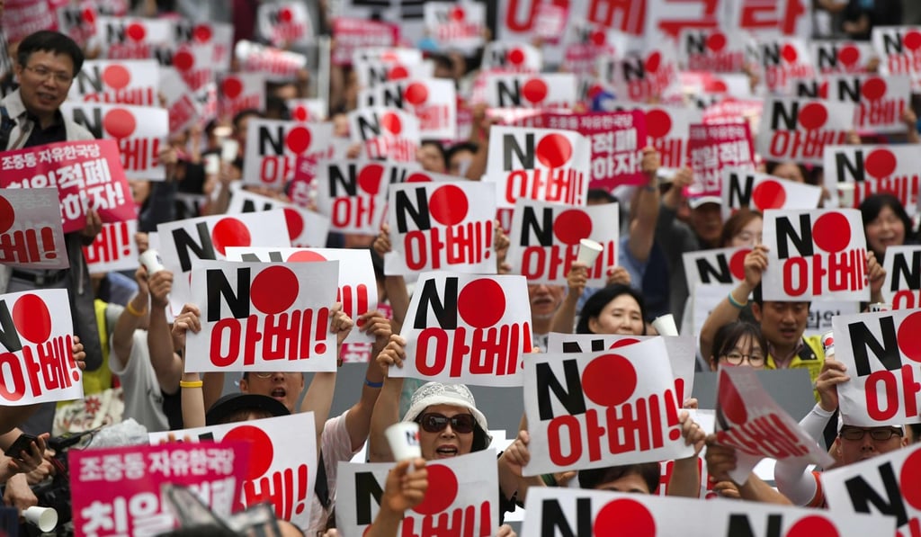 South Korean protesters hold up placards in Seoul denouncing Japan for its trade restrictions. Photo: AFP South Korean protesters hold up placards in Seoul denouncing Japan for its trade restrictions. Photo: AFP