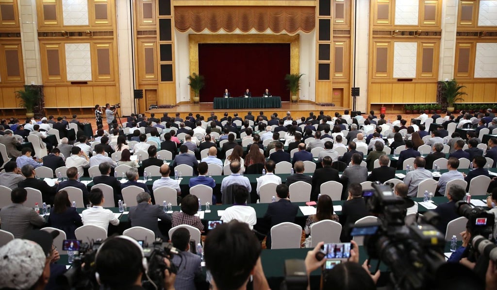 Yang Jianping, deputy director of Liaison Office of the Central People’s Government in Hong Kong (left), Zhang Xiaoming, director of the HKMAO, and Wang Zhimin, director of the Liaison Office (right), address the meeting in Shenzhen. Photo: Winson Wong