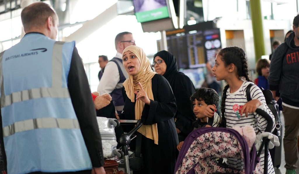 People talk to airport staff inside Heathrow Airport Terminal 5 as IT problems cause delays in London on Wednesday. Photo: Reuters People talk to airport staff inside Heathrow Airport Terminal 5 as IT problems cause delays in London on Wednesday. Photo: Reuters