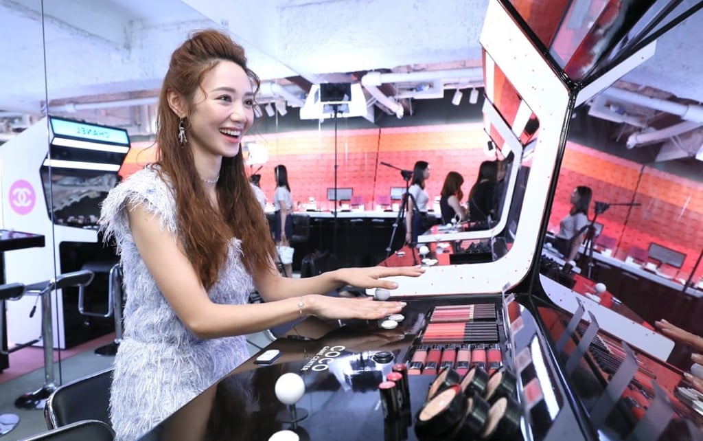 Actress Elva Ni plays at the Chanel's pop up Coco Game Center, the brand’s roadshow approach to hooking affluent millennials.