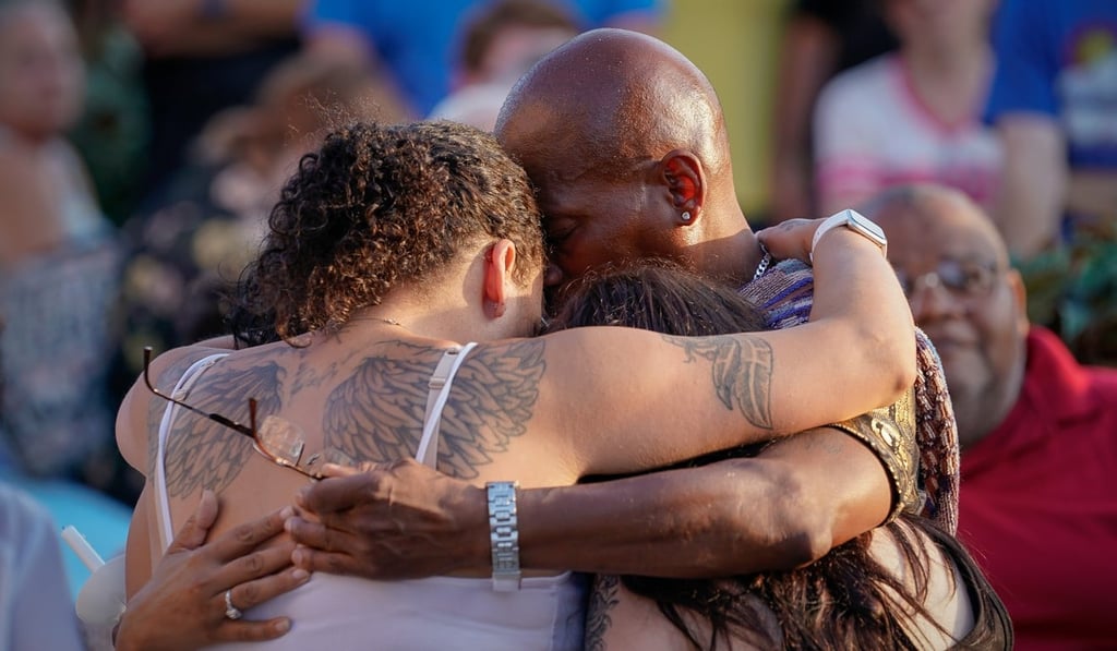 Mourners hug at a memorial service on Monday for victims of the Dayton shooting. Photo: Reuters