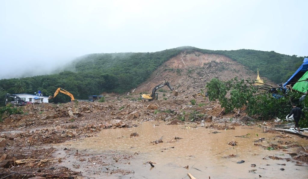 Earthmoving equipment is used to clear an area affected by a landslide in Paung, Myanmar. Photo: AFP Earthmoving equipment is used to clear an area affected by a landslide in Paung, Myanmar. Photo: AFP