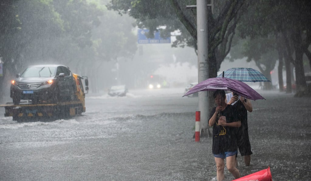 Residents of Ningbo city in Zhejiang wade through floodwaters. Photo: Reuters Residents of Ningbo city in Zhejiang wade through floodwaters. Photo: Reuters