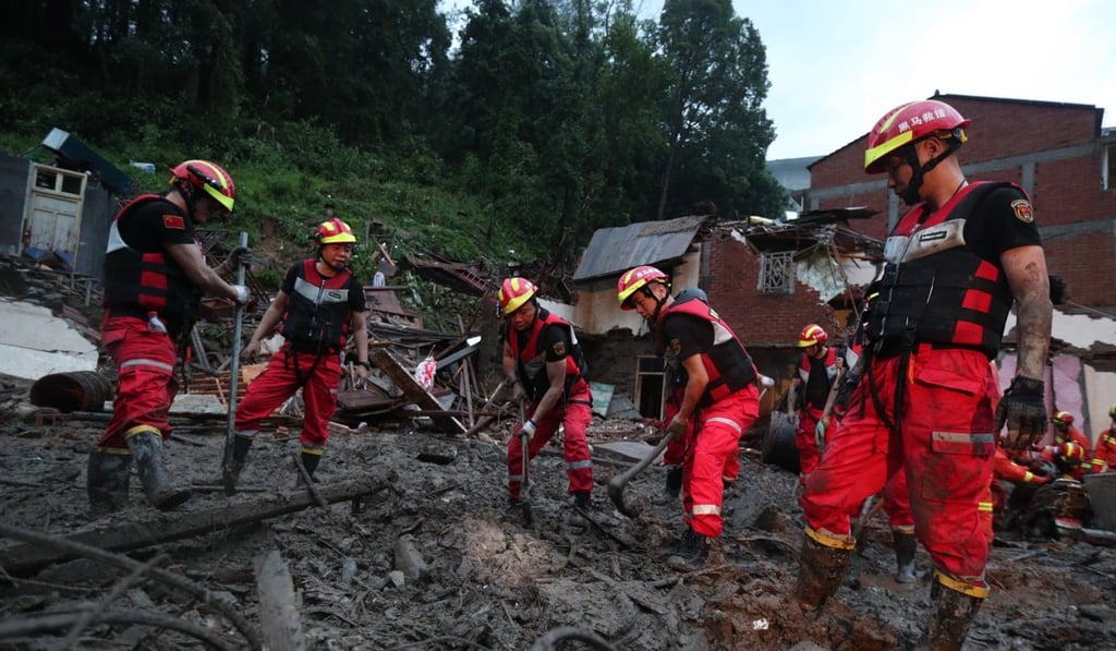 Rescuers try to clear a landslide in Yongjia country. Photo: EPA-EFE Rescuers try to clear a landslide in Yongjia country. Photo: EPA-EFE