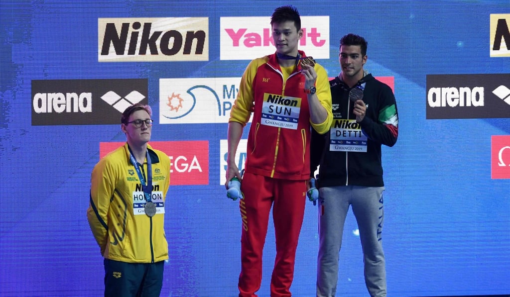 Australia's Mack Horton (L) refuses to stand on the podium with gold medallist China's Sun Yang (C) after the final of the men's 400m freestyle at the 2019 World Championship. Photo: AFP