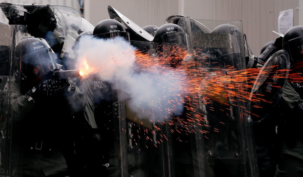 Hong Kong police officers fire tear gas at demonstrators on July 27. Photo: Reuters