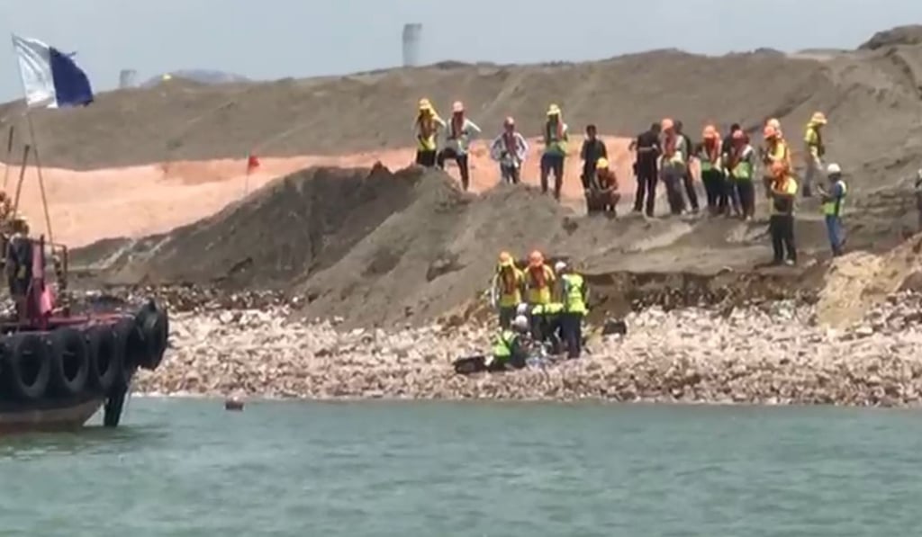The man was fished out of the water by divers after the bulldozer he was driving fell into the sea. Photo: Facebook