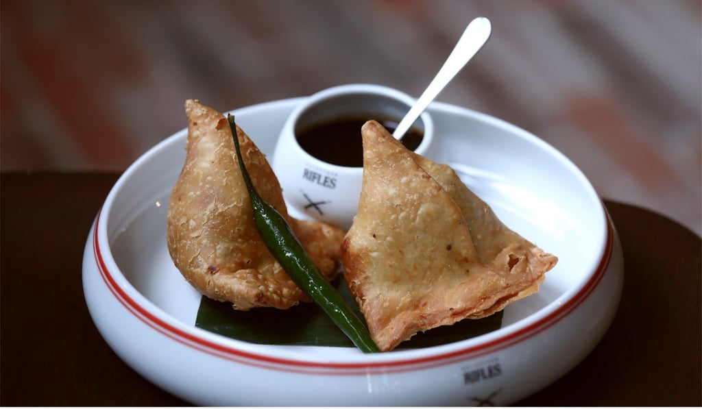 Samosas with tamarind chutney. Photo: Jonathan Wong