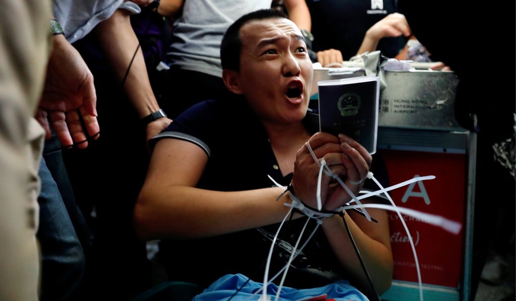 Hong Kong’s protesters aroused anger in Beijing when footage circulated of them tying up Fu Guohao, a reporter for China’s Global Times newspaper, during their mass demonstration at the Hong Kong International Airport on August 13. Photo: Reuters