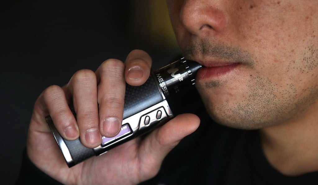 A young adult uses an e-cigarette in San Francisco, California. Photo: AFP