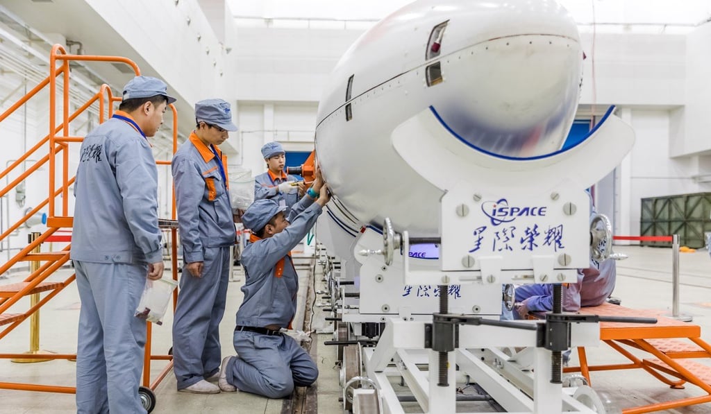 Workers assemble to rocket. Photo: Xinhua