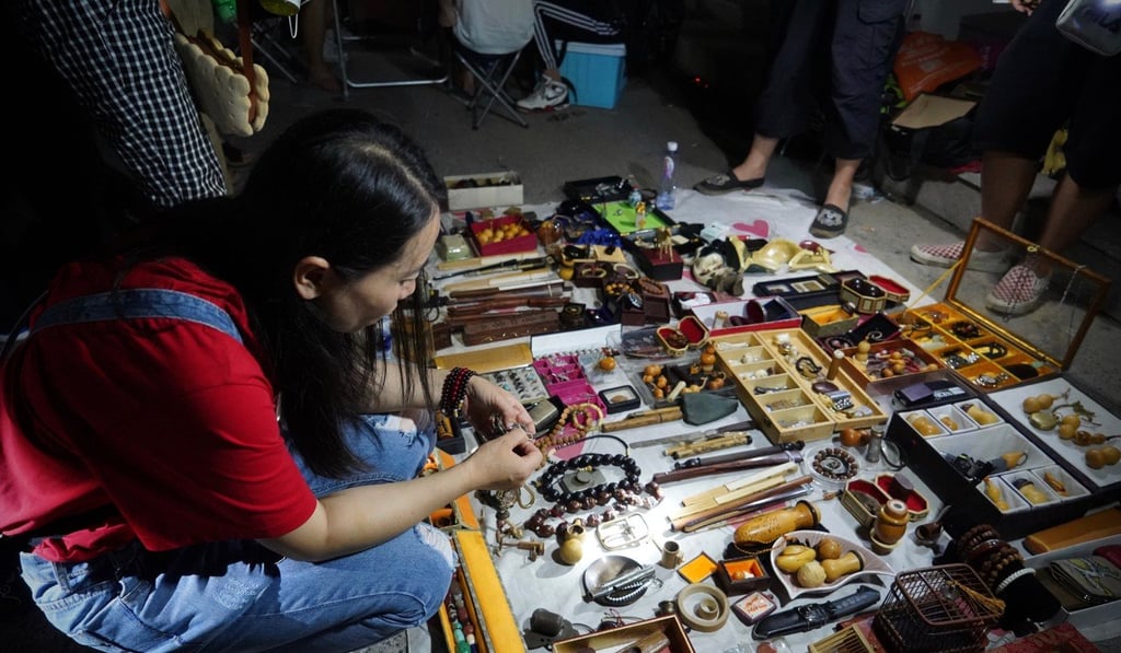 A bargain hunter searches through the antiques at the Daliushu ghost market. Photo: Tom Wang