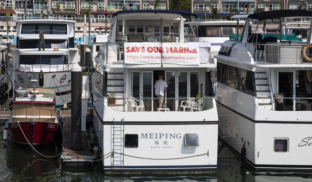 A banner reading ‘Save Our Marina’ is displayed on a boat moored at Discovery Bay on Lantau Island in 2018. About 150 families living on board vessels in the area were evicted in that year for renovation of the marina. Photo: Bloomberg