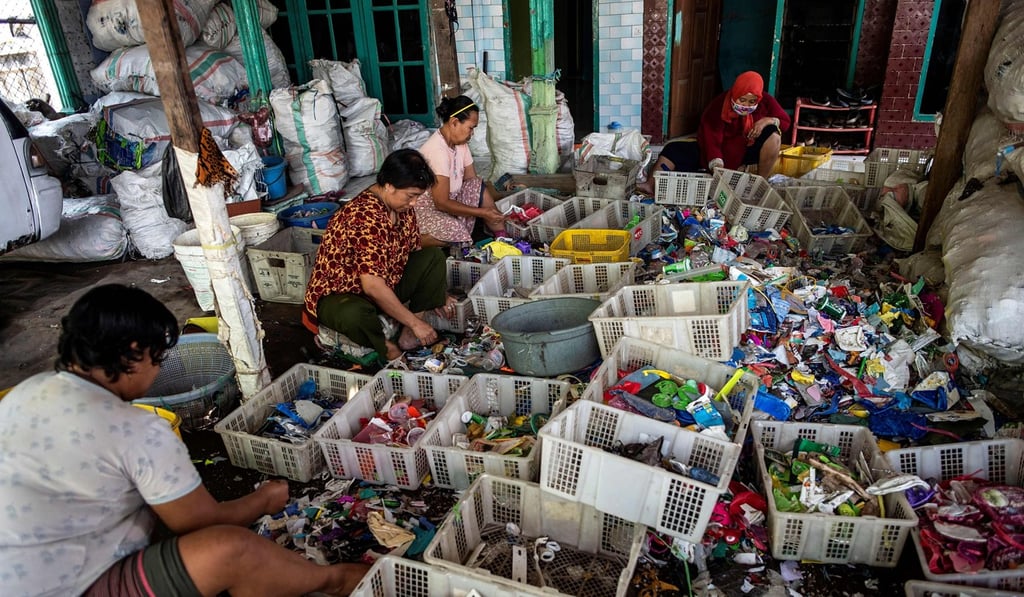People sift through plastic waste in Bangun, Indonesia. Photo: AFP People sift through plastic waste in Bangun, Indonesia. Photo: AFP