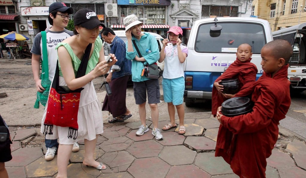 A photo op with young monks in Yangon. Photo: EPA