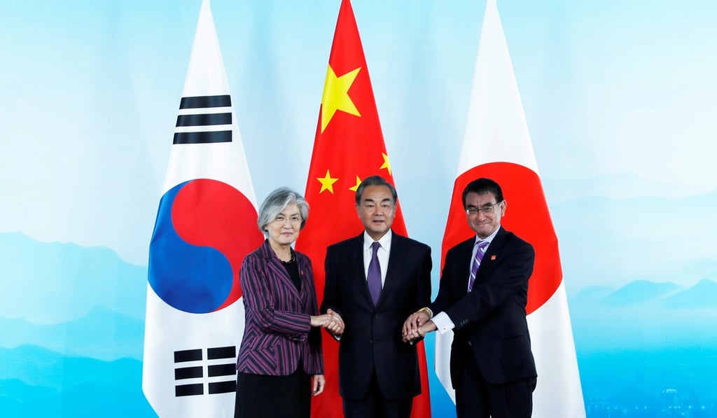 South Korean Foreign Minister Kang Kyung-wha, Chinese Foreign Minister Wang Yi and Japanese Foreign Minister Taro Kono shake hands ahead of a trilateral meeting in Beijing on Wednesday August 21. Photo: Reuters South Korean Foreign Minister Kang Kyung-wha, Chinese Foreign Minister Wang Yi and Japanese Foreign Minister Taro Kono shake hands ahead of a trilateral meeting in Beijing on Wednesday August 21. Photo: Reuters