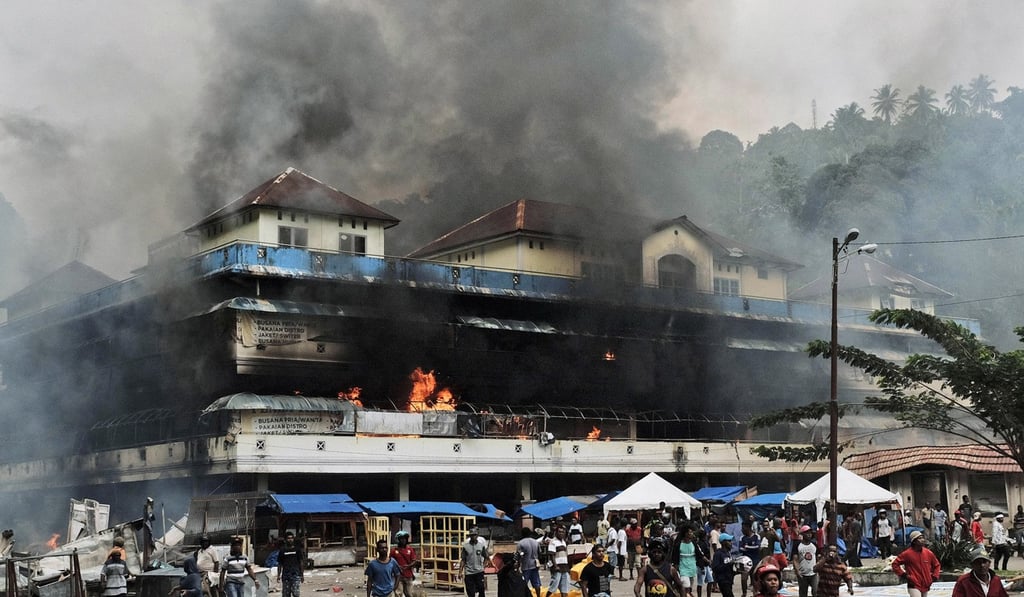 A market burns during a protest in Fakfak, Papua. Photo: AP A market burns during a protest in Fakfak, Papua. Photo: AP