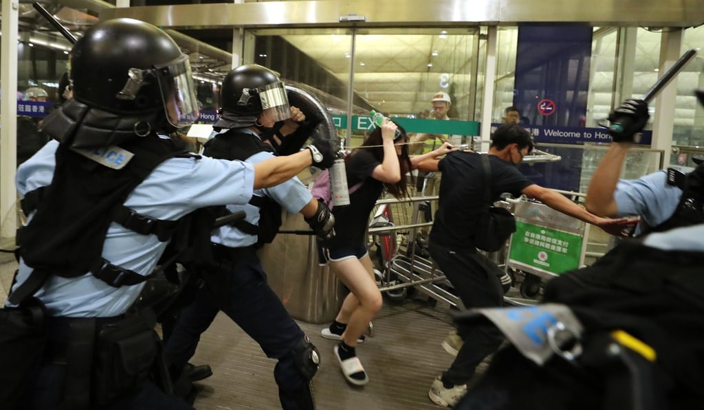 Riot police deploy pepper spray during a clash with protesters at Hong Kong International Airport on August 13. Photo: Sam Tsang Riot police deploy pepper spray during a clash with protesters at Hong Kong International Airport on August 13. Photo: Sam Tsang