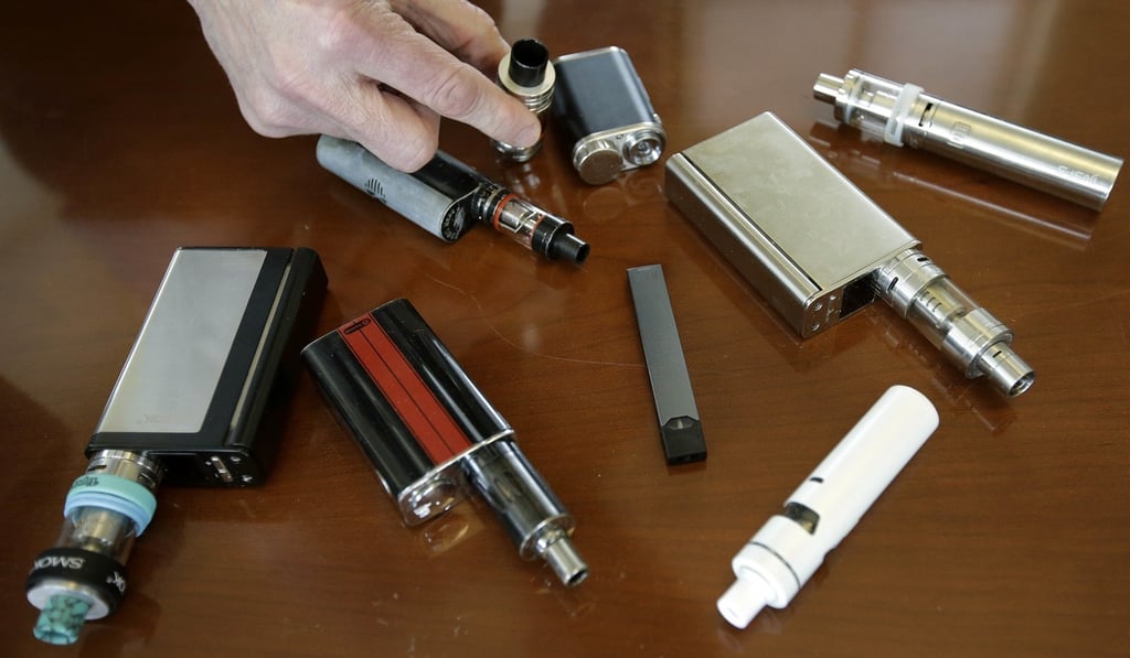 A Massachusetts high school principal displays vaping devices that were confiscated from students in April 2018. Photo: AP