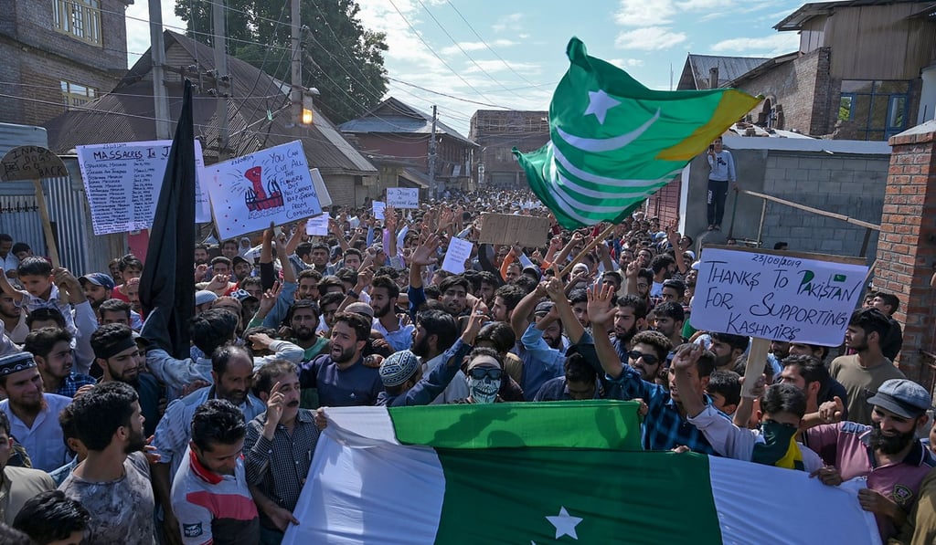 Protesters shout anti-India slogans and wave the flag of Pakistan-administered Kashmir in the Soura district of Srinagar on Friday. Photo: AFP