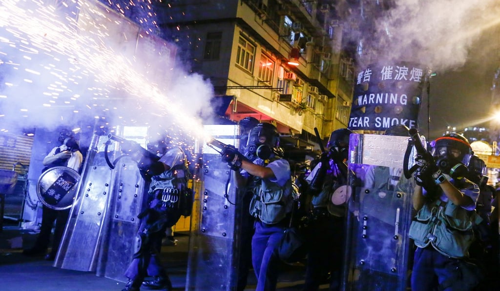 Police fire tear gas at protesters in Sham Shui Po. Photo: Reuters