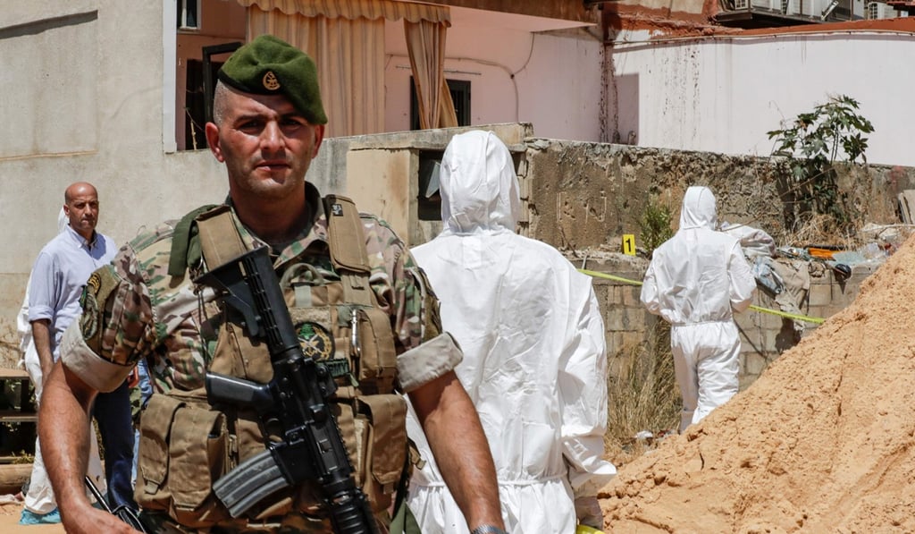 Lebanese military intelligence forensic investigators inspect the scene of the crashes. Photo: AFP