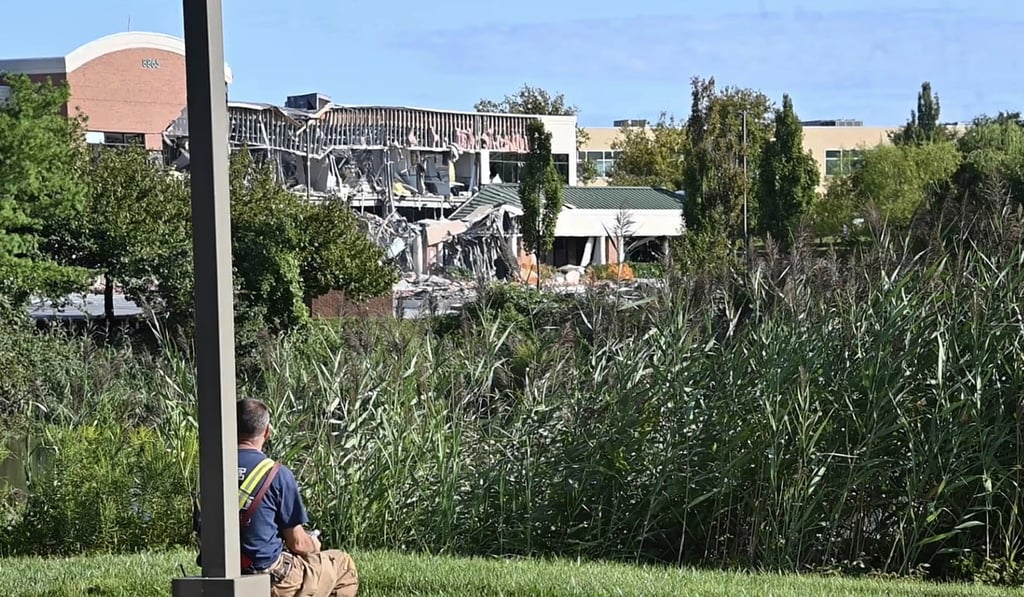 A Howard County emergency responder looks on at the damage caused by a gas explosion at the Lakeside Office Park in Columbia. Photo: The Baltimore Sun via AP