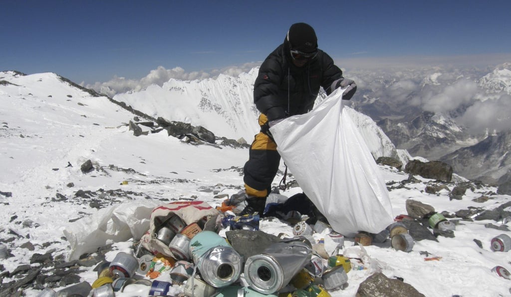 A Nepalese mountain guide collects garbage left by climbers on Mount Everest. Photo: AFP