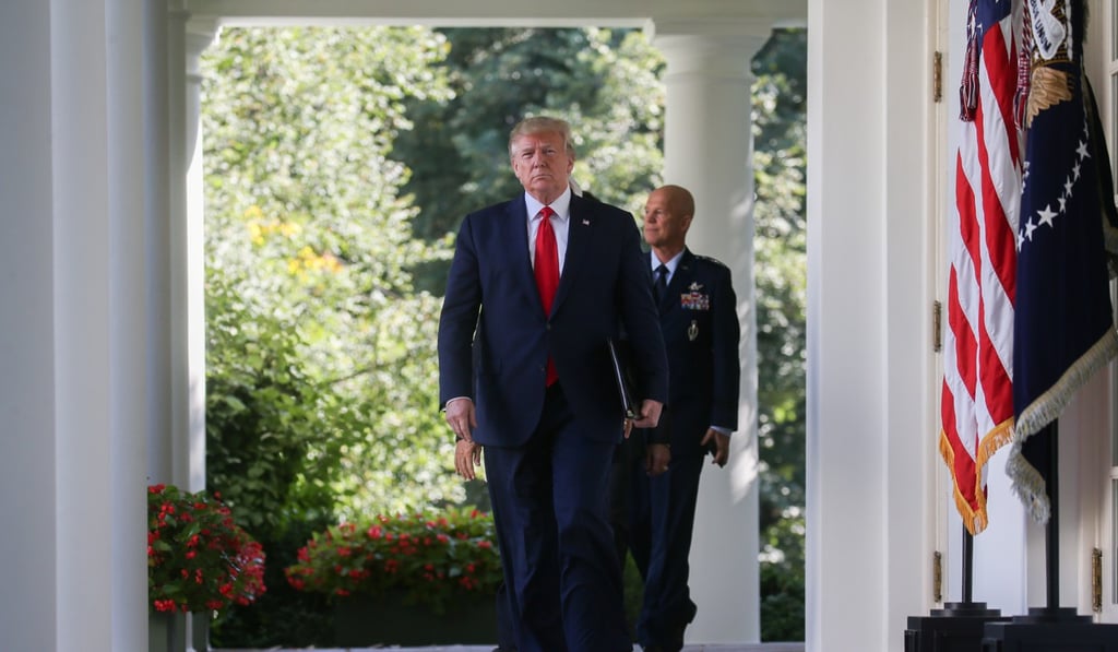 Trump walks from the Oval Office with US Air Force General John Raymond, commander of SpaceCom. Photo: Reuters