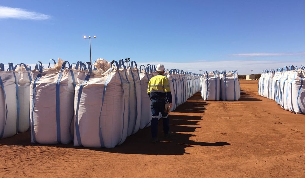 A Lynas worker in Perth walks past sacks of rare earths concentrate waiting to be shipped to Malaysia. Photo: Reuters
