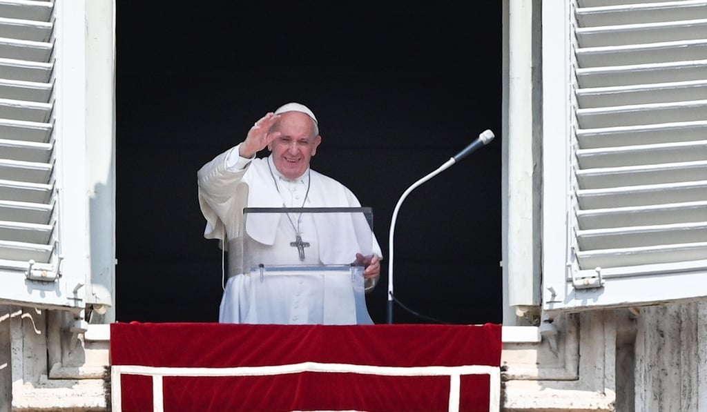 Pope Francis waves to worshipers as he speaks from the window of the apostolic palace overlooking St. Peter's square during the weekly Angelus prayer this month. Photo: AFP
