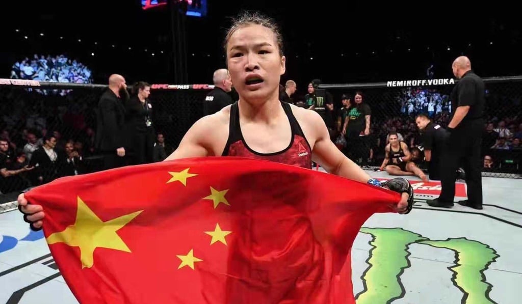 Zhang Weili celebrates with the Chinese flag. Zhang Weili celebrates with the Chinese flag.