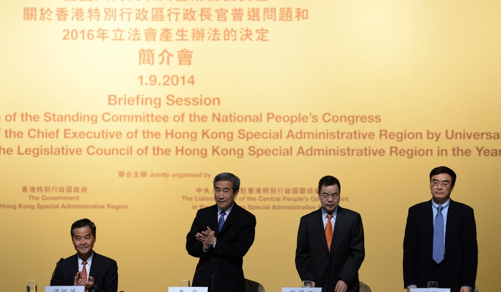 Left to right: Hong Kong Chief Executive Leung Chun-yin, Li Fei, vice-secretary general, National People’s Congress Standing Committee, Zhang Rongshun, vice-chairman of the Legislative Affairs Commission, NPCSC, and Feng Wei, deputy director, Hong Kong and Macau Affairs Office at a briefing session of the standing committee on September 1, 2014. Photo: Xinhua